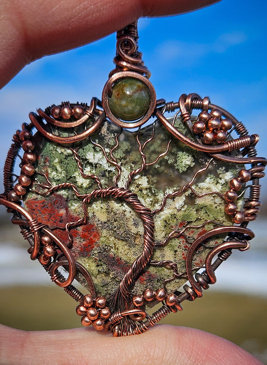 Handmade wire wrapped moss agate heart pendant in raw copper wire