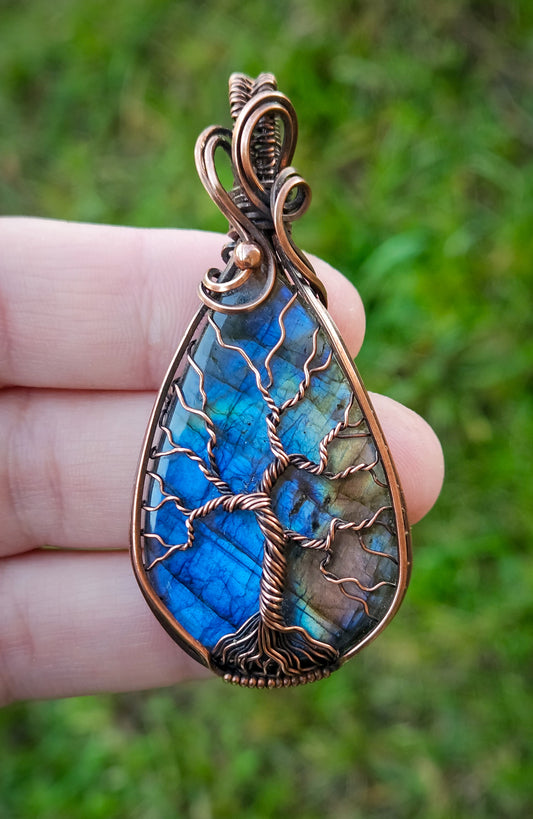 Wire wrapped beautiful blue flashy labradorite pendant in raw copper wire