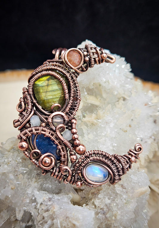 Wire wrapped moon pendant with labradorite, kyanite, moonstone and sunstone in copper