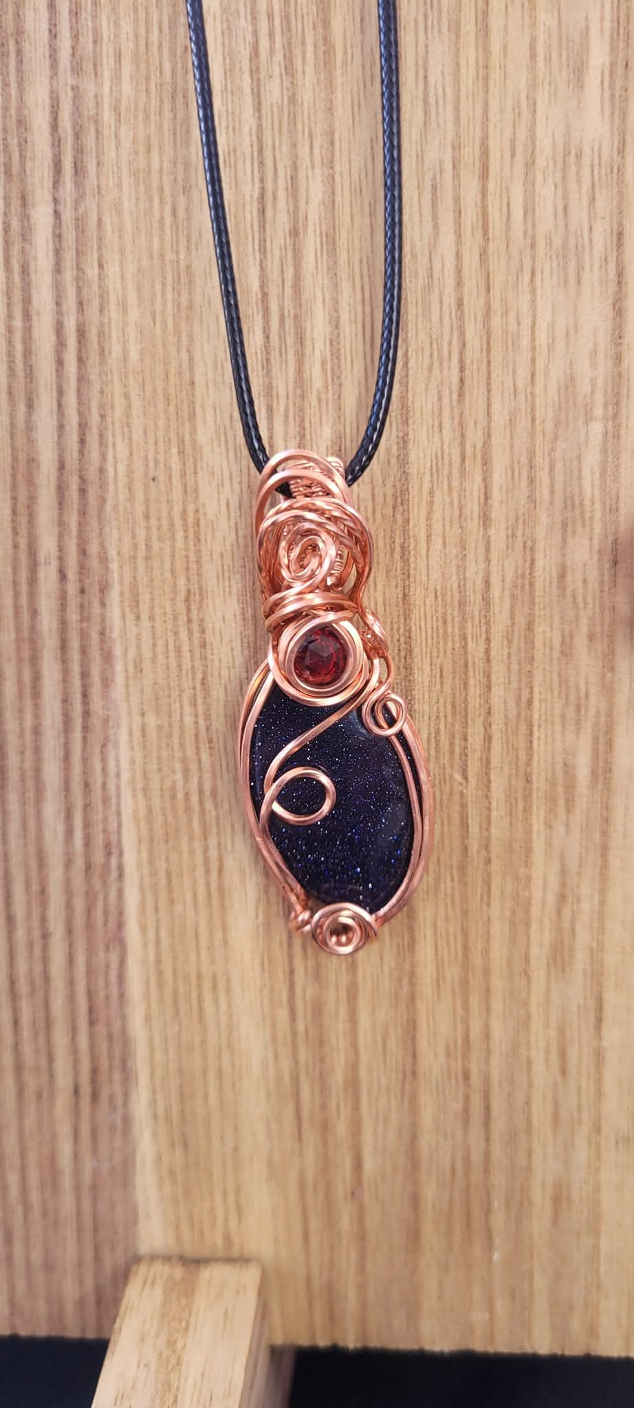 Blue Goldstone with garnet accent pendant