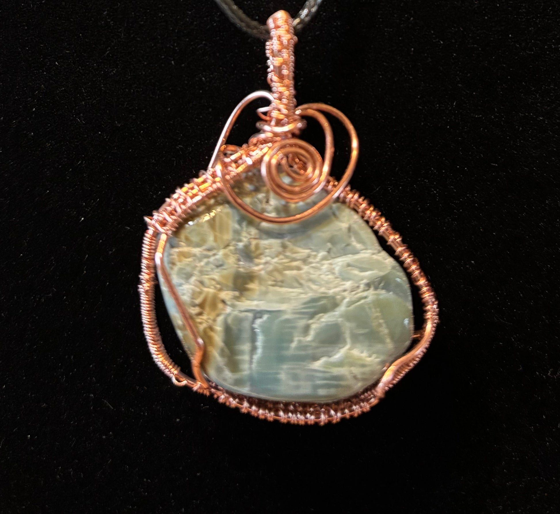 Light greens stone wrapped in copper